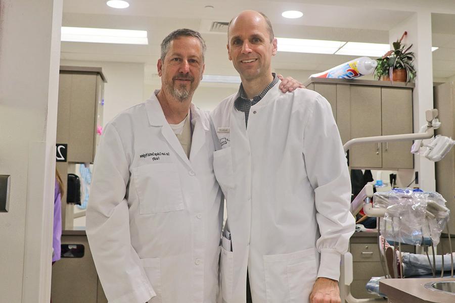 Drs. Gene Hilton and Julius Manz, shown side-by-side in the SJC Dental Clinic, have been working together on the GKAS event for many years.