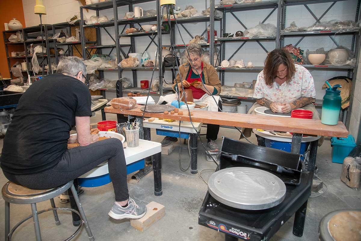 SJC students in a pottery class.