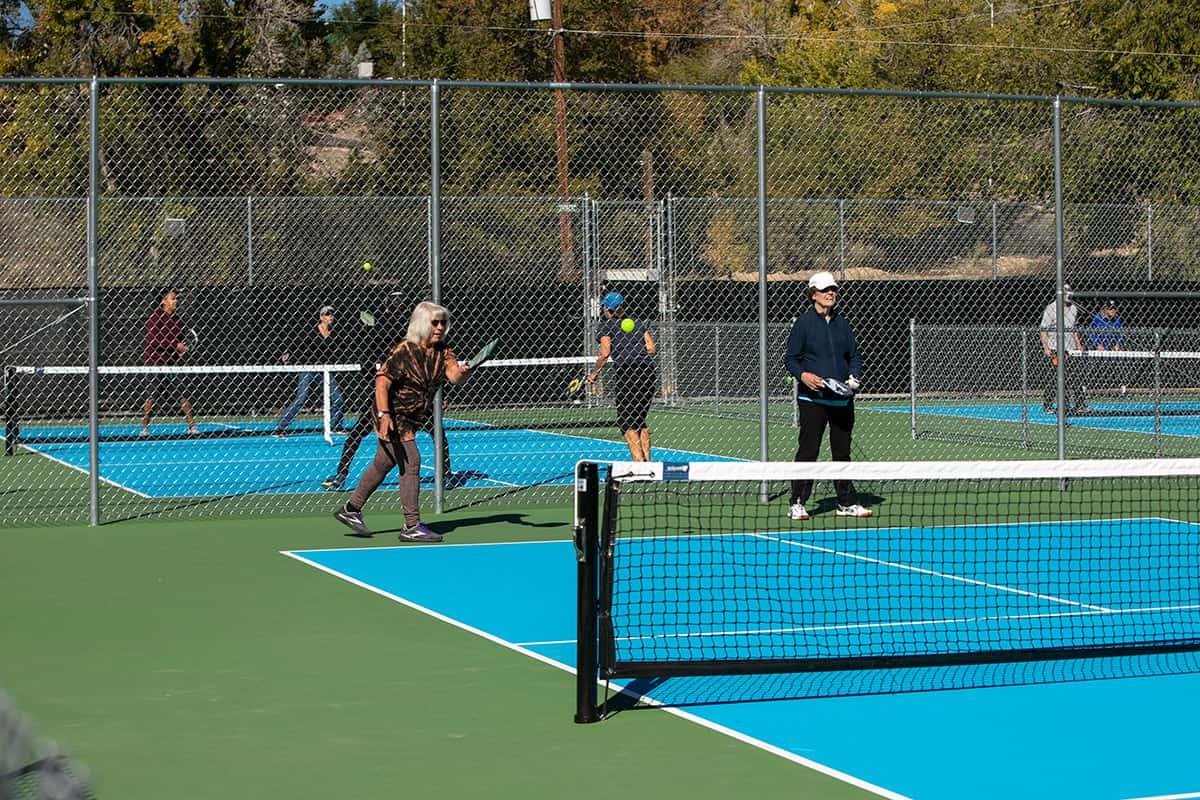 Pickleball player readies to return hit back to other player on a sunny day at the Brookside Park Pickleball courts.