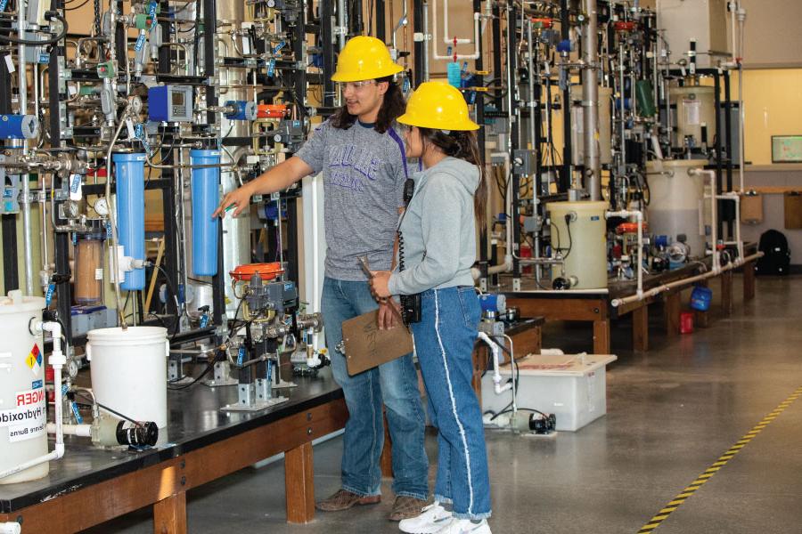 Two students exploring equipment in the School of Energy at San Juan College